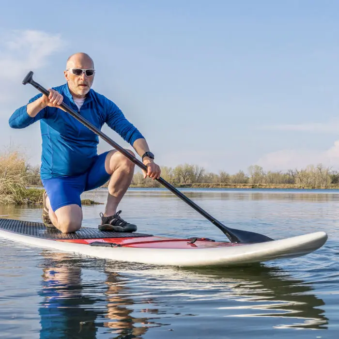 Senior man on a paddleboard